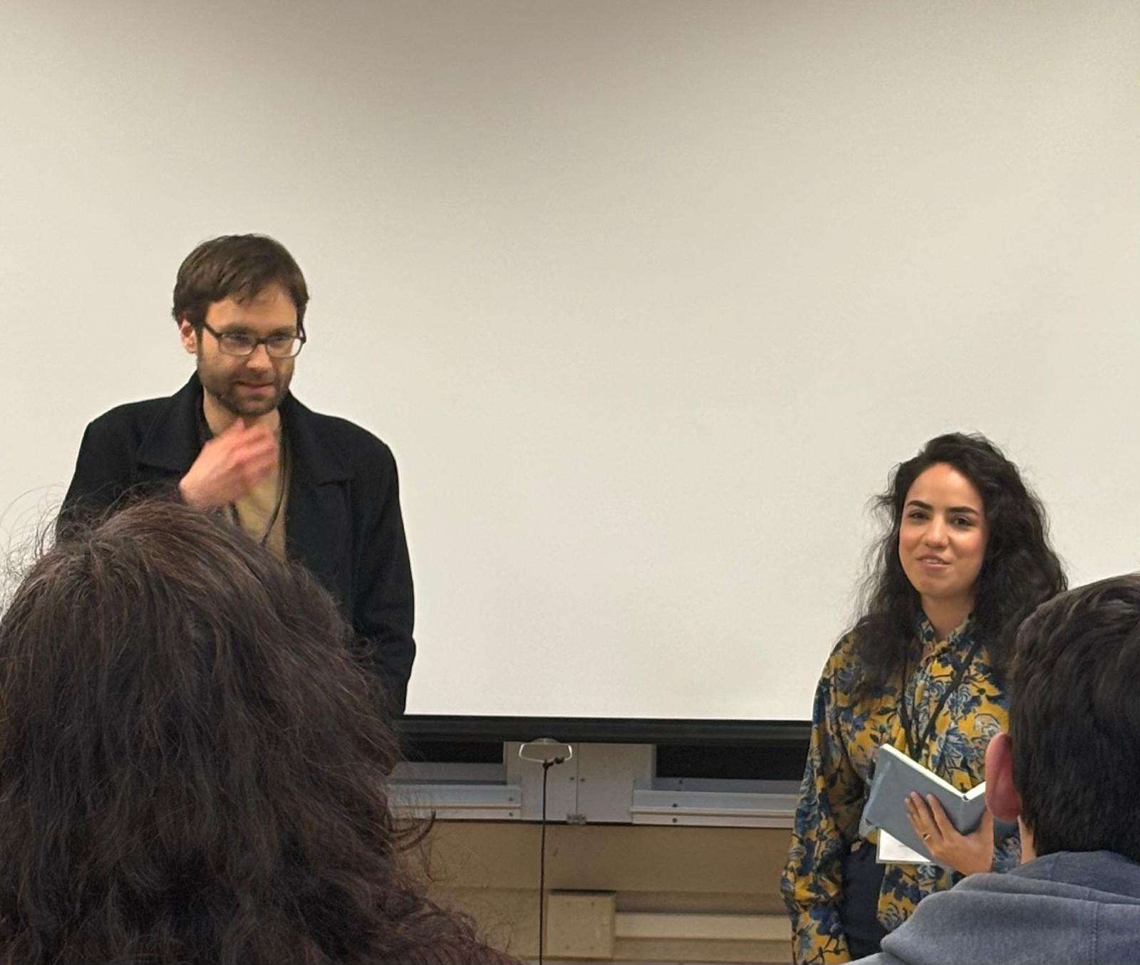 Robert Reimer and Ana L&oacute;pez speaking in front of an audience at the UIUC Grad Conference.